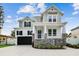 Stunning two-story home boasts a charming porch, gray siding, and a spacious two-car garage at 3404 S Omar Ave, Tampa, FL 33629