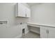 Laundry room with white cabinetry, mosaic flooring, and plenty of counter space at 3404 S Omar Ave, Tampa, FL 33629