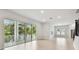 Bright living room with a sliding glass doors to a covered patio and wood-look floors at 3404 S Omar Ave, Tampa, FL 33629