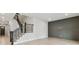 Spacious living room features modern staircase, wood-look floors, and chic accent wall at 3404 S Omar Ave, Tampa, FL 33629