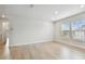 Living room features bright windows, light wood-look floors, and neutral color scheme at 3404 S Omar Ave, Tampa, FL 33629