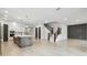 Open-concept living space with access to the kitchen and a modern staircase at 3404 S Omar Ave, Tampa, FL 33629
