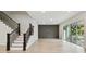 Spacious living room featuring wood-look floors and access to an outdoor patio at 3404 S Omar Ave, Tampa, FL 33629