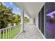 An elegant white porch with stone pavers, white columns, and a view of the lush landscape at 3404 S Omar Ave, Tampa, FL 33629