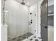 Glass enclosed shower with black hardware and marble tile surround at 3404 S Omar Ave, Tampa, FL 33629