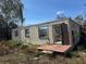 Image of a distressed single-story home with cinder block construction and overgrown landscaping at 342 Lettie Ln, Seffner, FL 33584