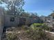 Image of the interior of a distressed single-story home with cinder block construction and overgrown landscaping at 342 Lettie Ln, Seffner, FL 33584