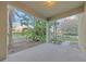 Spacious outdoor back patio area with palm trees at 3622 Wiregrass Rd, New Port Richey, FL 34655