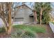 Side view of home with an attached garage, and yard with a white picket fence at 3622 Wiregrass Rd, New Port Richey, FL 34655