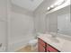 Bathroom featuring a vanity, toilet, and shower-tub combo at 3622 Wiregrass Rd, New Port Richey, FL 34655