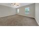 Bedroom showcasing neutral walls, plush carpeting, and sunlit windows at 3622 Wiregrass Rd, New Port Richey, FL 34655