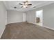 Bedroom featuring neutral walls, plush carpeting, and an adjacent bathroom for added convenience at 3622 Wiregrass Rd, New Port Richey, FL 34655