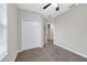 A comfortable bedroom features neutral walls, carpeted floors, a ceiling fan, and a closet at 3622 Wiregrass Rd, New Port Richey, FL 34655