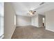 Spacious bedroom with neutral walls, plush carpeting, and easy access to the bathroom at 3622 Wiregrass Rd, New Port Richey, FL 34655