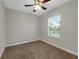 Cozy bedroom features neutral walls, carpeted floors, ceiling fan, and window with blinds at 3622 Wiregrass Rd, New Port Richey, FL 34655