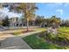 Scenic view of the neighborhood street with sidewalks, landscaping and a Longleaf Veterans Field sign at 3622 Wiregrass Rd, New Port Richey, FL 34655