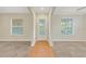 Bright, open foyer featuring tile flooring, white trim, and natural light at 3622 Wiregrass Rd, New Port Richey, FL 34655
