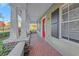 Inviting front porch with brick flooring, columns, and stylish exterior at 3622 Wiregrass Rd, New Port Richey, FL 34655
