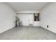 View of the garage featuring a water heater, water softener, and plenty of space at 3622 Wiregrass Rd, New Port Richey, FL 34655