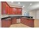 View of the kitchen featuring stainless steel appliances, dark granite countertops, and dark wood cabinets at 3622 Wiregrass Rd, New Port Richey, FL 34655