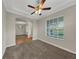 View of the living room featuring plush carpeting, a large window, and entry to the dining room at 3622 Wiregrass Rd, New Port Richey, FL 34655