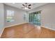 The living room has hardwood floors, a ceiling fan, a sliding glass door, and multiple windows at 3622 Wiregrass Rd, New Port Richey, FL 34655