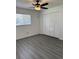 Bright bedroom with gray laminate flooring, closet and a window at 4216 & 4218 76Th W St, Bradenton, FL 34209