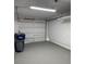 Spacious garage with a white door and grey painted floors at 4216 & 4218 76Th W St, Bradenton, FL 34209