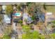 An aerial view of the property showcasing its layout, backyard pool, and mature trees at 560 80Th N Ave, St Petersburg, FL 33702