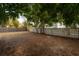 Large backyard with a unique concrete block fence and mature trees at 560 80Th N Ave, St Petersburg, FL 33702
