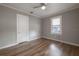 Neutral bedroom features a ceiling fan, a window, and wood-look flooring at 560 80Th N Ave, St Petersburg, FL 33702