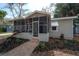 Attractive house featuring a screened porch, with a manicured lawn and a brick walkway at 560 80Th N Ave, St Petersburg, FL 33702