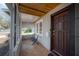 Inviting front porch with tiled floor, chairs, and a view of the entry door at 560 80Th N Ave, St Petersburg, FL 33702