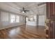 Bright living room boasts decorative ceiling, wood floors, and seamlessly connects to the updated kitchen at 560 80Th N Ave, St Petersburg, FL 33702
