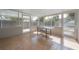 Enclosed patio area featuring tile flooring and an outdoor dining set for entertaining at 560 80Th N Ave, St Petersburg, FL 33702