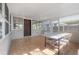 Enclosed patio area featuring tile flooring and an outdoor dining set with access to the backyard at 560 80Th N Ave, St Petersburg, FL 33702