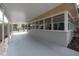 Covered patio with a concrete floor, screens, and large sun windows at 560 80Th N Ave, St Petersburg, FL 33702
