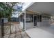 Spacious covered patio with screens and an exterior door that leads to a fenced yard at 560 80Th N Ave, St Petersburg, FL 33702