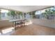 Enclosed patio area featuring tile flooring and an outdoor dining set with views to the yard at 560 80Th N Ave, St Petersburg, FL 33702
