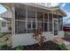 Cozy screened porch with tiled flooring, views of the front yard and home's exterior at 560 80Th N Ave, St Petersburg, FL 33702