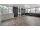 Bright sunroom featuring many windows, modern wood-look tile flooring, and painted brick and half wall wainscoting at 560 80Th N Ave, St Petersburg, FL 33702