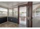 Bright sunroom with tile flooring and paneled walls visible through an open door at 560 80Th N Ave, St Petersburg, FL 33702