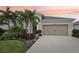 Charming single-story home with neutral paint, two-car garage, and mature tropical landscaping at 5809 Silver Sun Dr, Apollo Beach, FL 33572