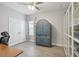 Bright home office with hardwood floors, natural light, and unique glass-door display cabinet at 5809 Silver Sun Dr, Apollo Beach, FL 33572