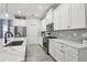 Bright kitchen with white cabinets, stainless steel appliances, and marble countertops with geometric backsplash at 5809 Silver Sun Dr, Apollo Beach, FL 33572