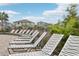 Rows of comfy lounge chairs line the pool area, with lovely landscaping and community homes in the background at 5809 Silver Sun Dr, Apollo Beach, FL 33572