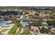 Aerial view of a home near a main road, featuring mature trees and well-maintained landscaping at 5997 45Th N Ave, Kenneth City, FL 33709