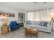 Cozy living room with sofa, side chair, coffee table, and decorative shelving at 5997 45Th N Ave, Kenneth City, FL 33709