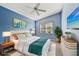 Stylishly staged main bedroom with blue walls, decor, and a ceiling fan at 6431 43Rd E Ct, Sarasota, FL 34243