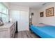 Bright bedroom featuring cool tones, natural light, a closet, and stylish decor elements, creating a serene retreat at 7015 N Dakota Ave, Tampa, FL 33604
